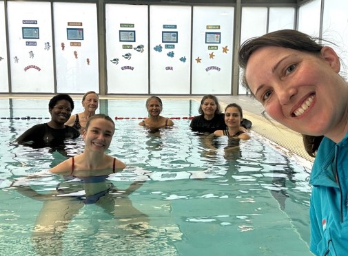 Photo of instructor water walking participants together